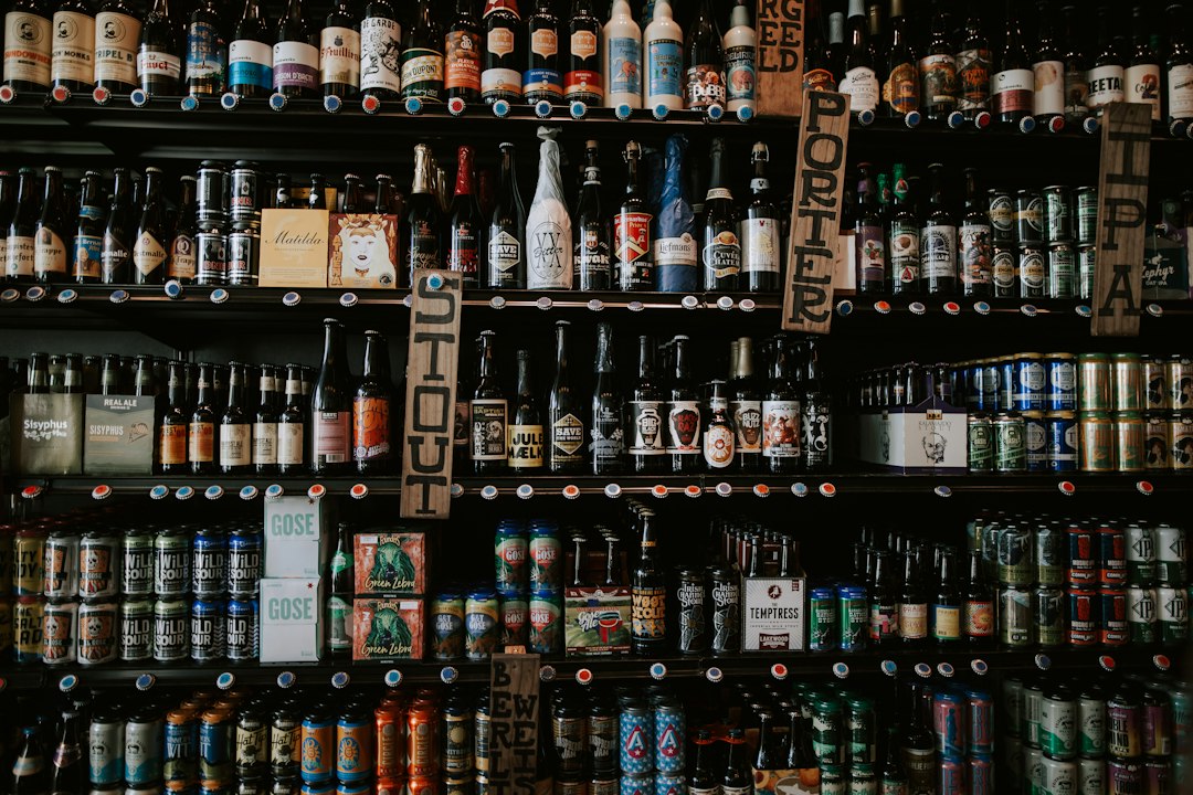 Rows of beer bottles on shop shelves, illustrative photograph